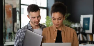 Man and woman looking at a White Tablet Computer