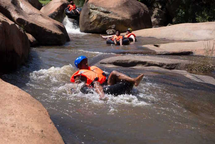Mqeku tubing at Mqeku Picnic Site, featuring a natural waterslide