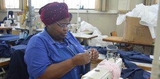 Zethu Soya, of Port Elizabeth, goes through her daily job as a seamstress at the Association for Persons with Physical Disabilities in Port Elizabeth. She says her life has been changed since receiving a wheelchair through the SPAR Wheelchair Wednesday campaign. Photo: Full Stop Communications
