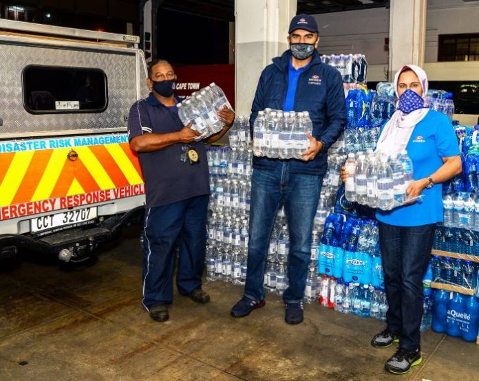 Engen staff were on hand at Roeland Street Fire Station to help unpack bottled water and lend a helping hand where needed. Pictured (L-R) are Engen General Manager: Corporate Strategy and Communications, Khalid Latiff (centre); and Engen Corporate Social Investment Manager: Adhila Hamdulay (right).