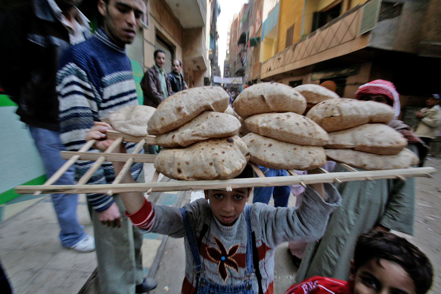 A boy carries bread in Egypt.