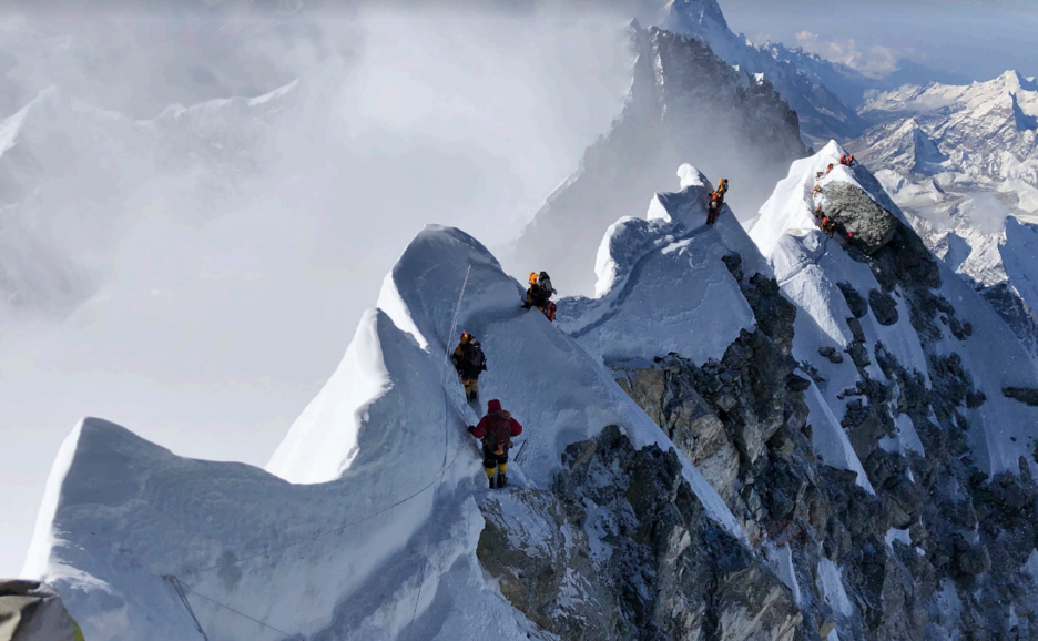 Mountaineers at knife-edge ridge below the Sagarmatha summit.