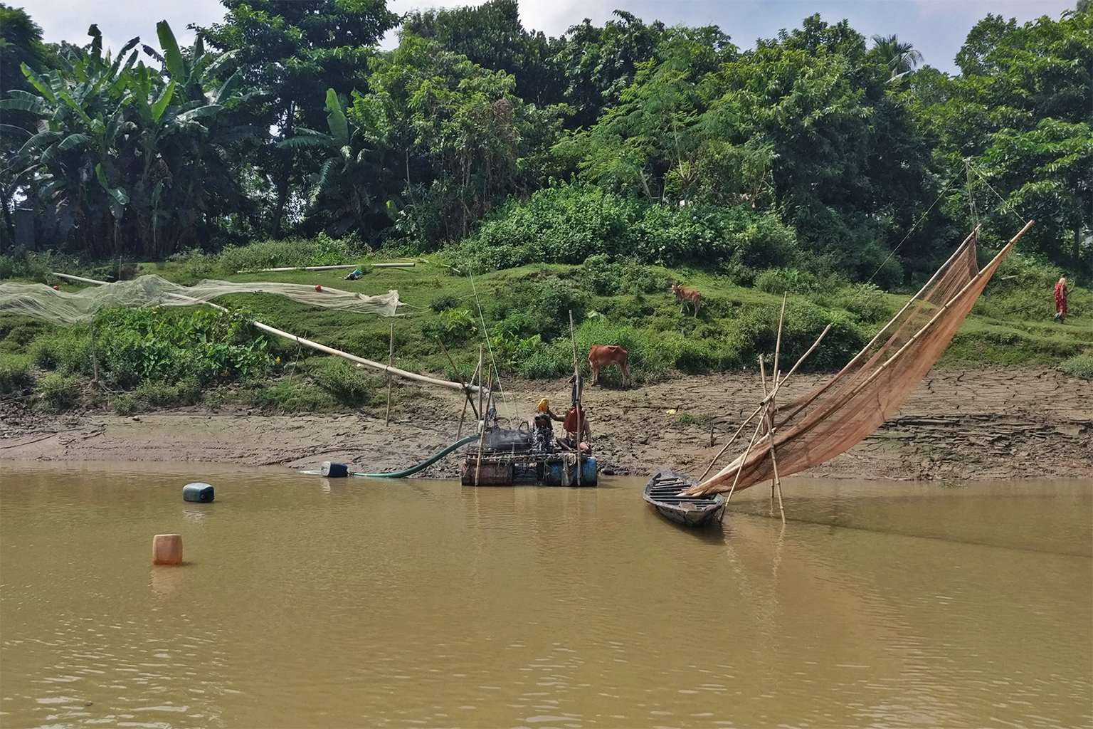 Sand mining on the riverbanks.