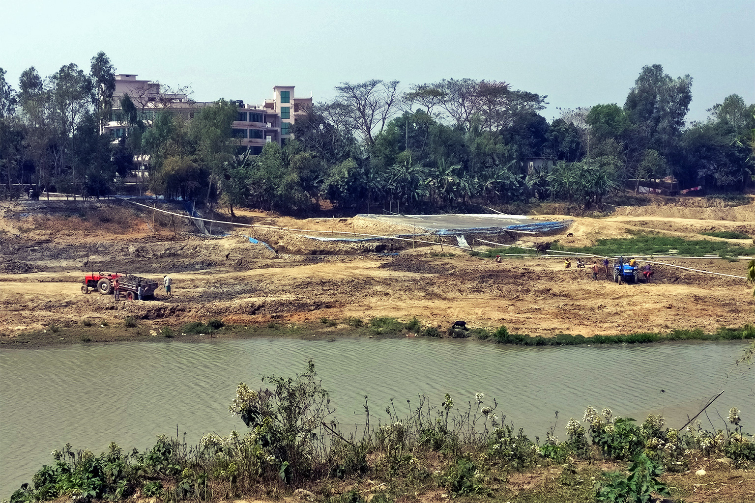 Sand mining on the riverbanks.
