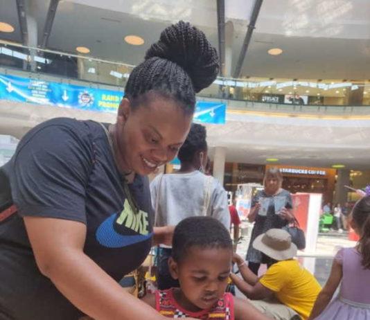 Visitor paints with her daughter at the Rand Show Spring Edition taking place at Fourways Mall