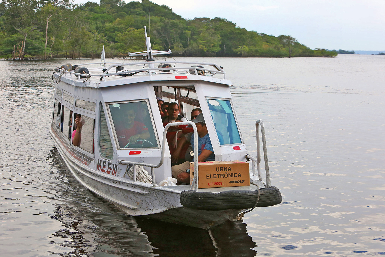 A boat arrives at a riverside community on the banks of the Rio Negro.