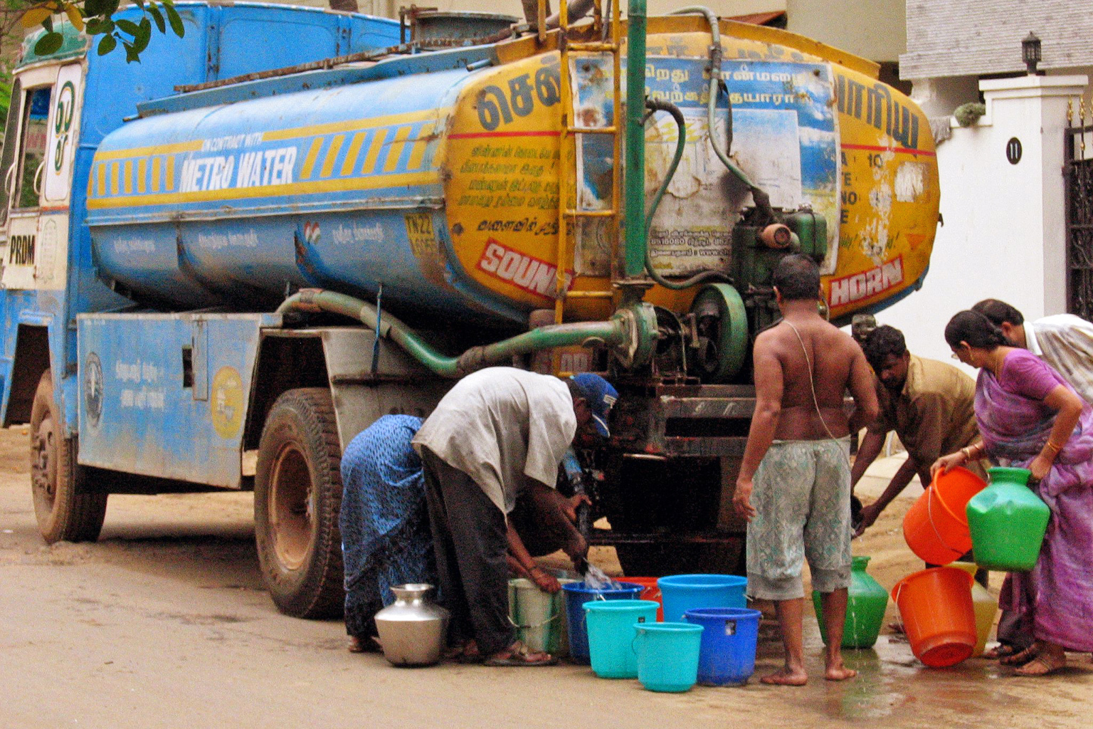 People collect water from a water tanker