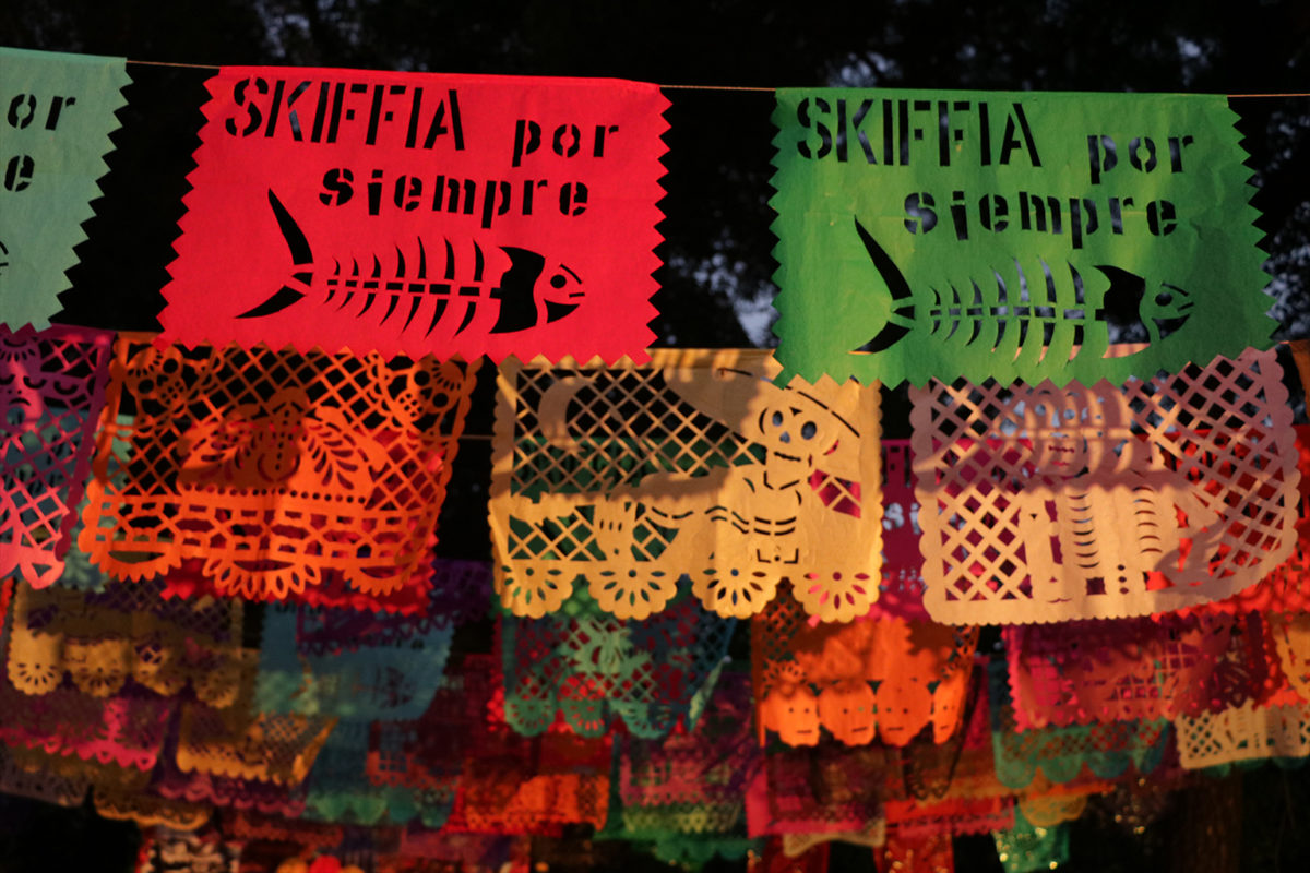 Flags at the golden skiffia themed Day of the Dead altar.