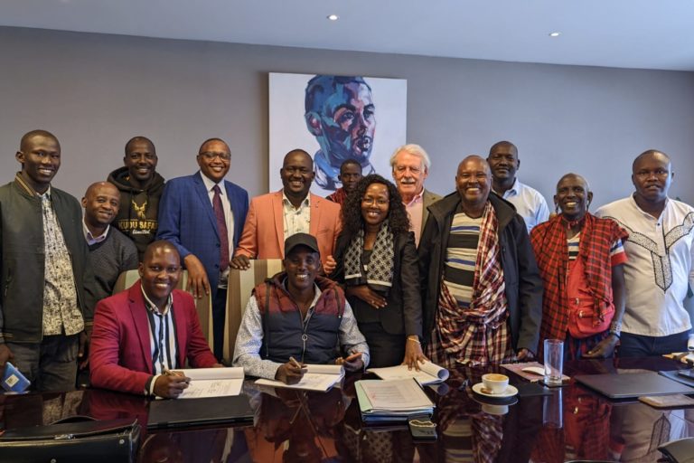 Chairman Joel Karori (middle, front) signs a new lease agreement with Great Plains, accompanied by Secretary Daniel Kishanto (left, front) and other community leaders. Image courtesy Daniel Kishanto.