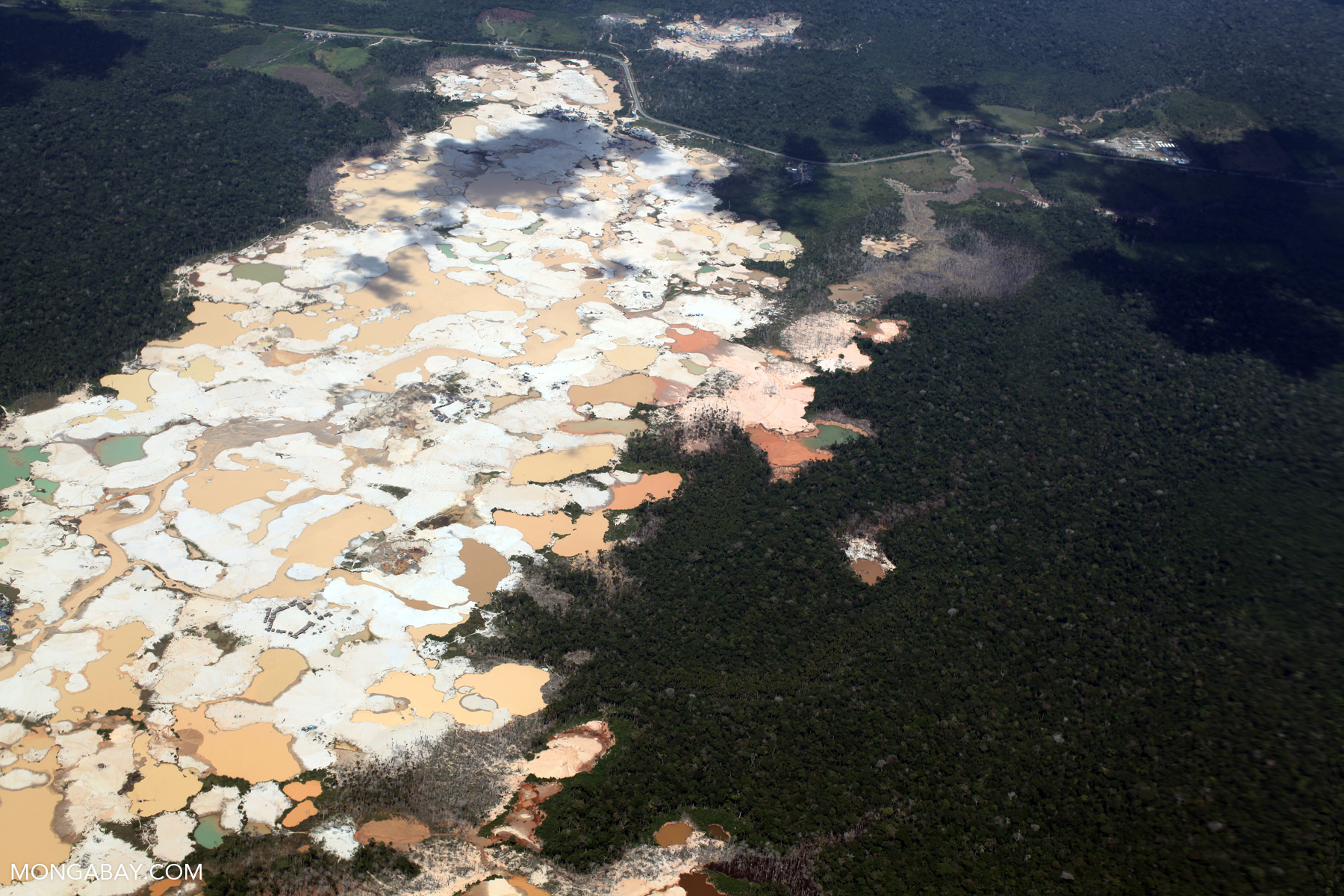 Aerial view of Amazon rainforest landscape scarred by open pit gold mines