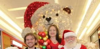 St Martins Children’s Home volunteers - Christopher Holmes and Kaylee Aitken with Eddie Locke (Santa)
