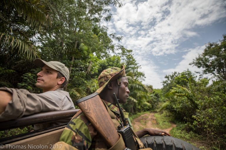 Scientist Mathias D’haen (l) rides through Garamba National Park with a ranger. Photo by Thomas Nicolon for Mongabay.