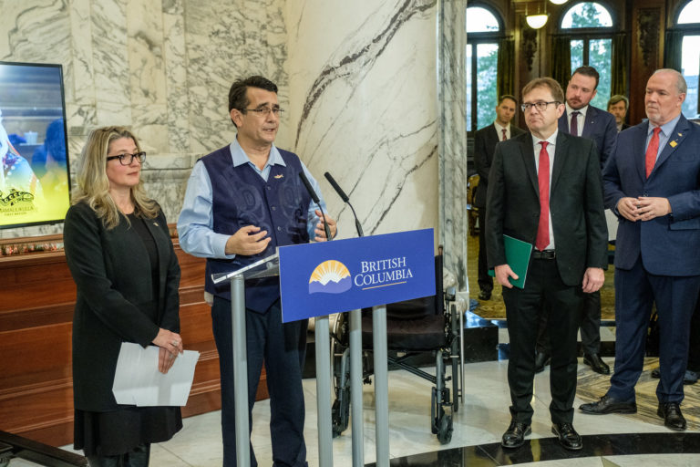 Chief Robert Chamberlin speaks at a press conference for the government-to-government agreement with the provincial government of British Columbia to create a transition plan for 17 fish farms. Image by Province of British Colombia via Flickr (CC BY-NC-ND 2.0). 