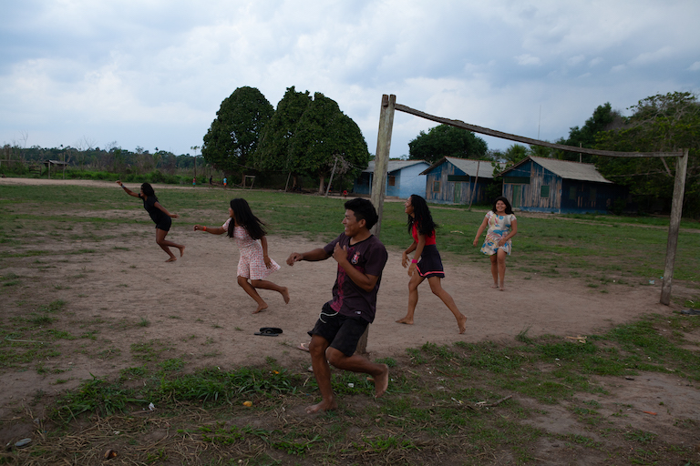 Teenagers play soccer and chase each other in the main village in Apyterewa Indigenous reserve, located in São Félix do Xingu, in the Brazilian state of Pará. The territory has been demarcated since 2007 but it has increasingly come under pressure as land-grabbers, loggers and ranchers invade slices of it and raze the rainforest. Photo by Ana Ionova for Mongabay.