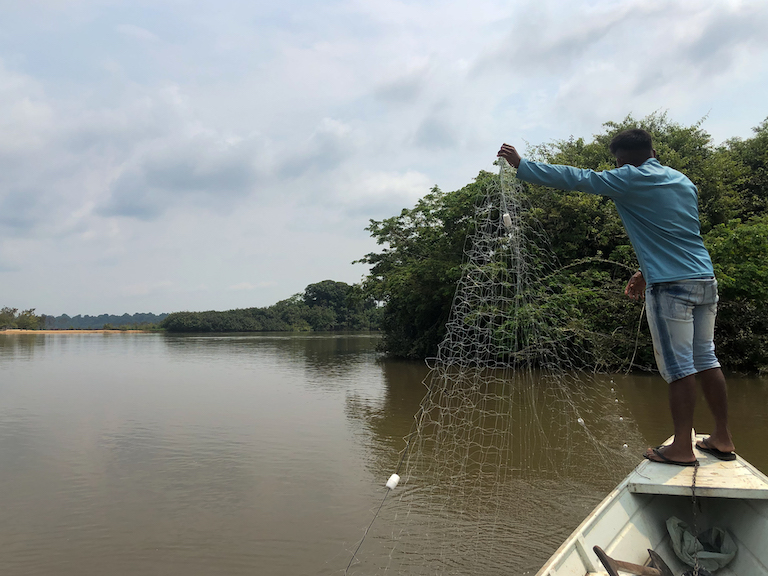A Parakanã man casts a fishing net in the Xingu River, in the Apyterewa Indigenous reserve. The Indigenous community says illegal mining on their territory is polluting the river and putting their traditional way of life at risk. Photo by Ana Ionova for Mongabay.