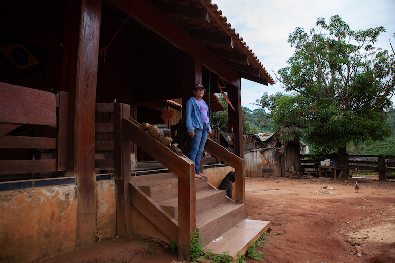 Dorcas Cruz, one of the settlers illegally occupying a slice of land in Apyterewa Indigenous Reserve, poses in front of her wooden ranch. Authorities destroyed her house in 2011, in an attempt to evict the community, but Cruz and her family came back and rebuilt in the same spot. Photo by Ana Ionova for Mongabay.