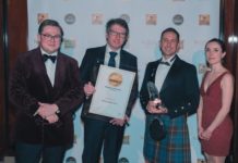 Neil Paterson (centre left) with Marc Pendlebury (centre right) with the representatives from Whisky Magazine presenting the award.