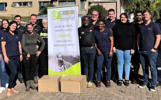 The Motion Tronic Team handing over items collected to members from the Jes Foord Foundation