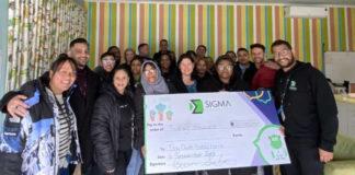 Nicole Pillay from Sigma Connected handing over the cheque to Kim Allen-from Tiny Owls Baby Home