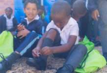 Stepping into success - Xavier Pretorius and Achuma Dingiswayo eagerly try on their new shoes