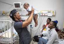 Operation Smile volunteer nurse Mildred Ramathole holds up one of the babies at Rob Ferreira hospital May 2023