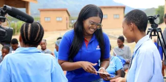 Engen CSI Manager Olwethu Mdabula hands out menstrual care info to learners at Tekanang Secondary School