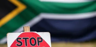 Donald Trump presents a pack of paper to Ramaphosa with murdered farmers on it