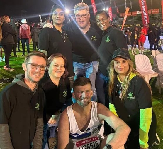 Pictured above: Graham and the PMB Homeless Network after completing the Comrades in 2024.