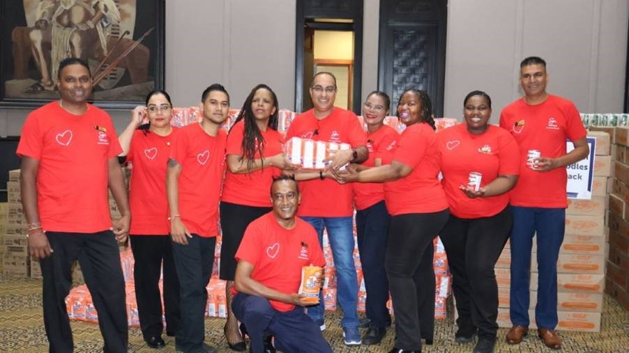 Leading by example, Virath Gobrie guides the Sibaya team as they spend the day packing for the community