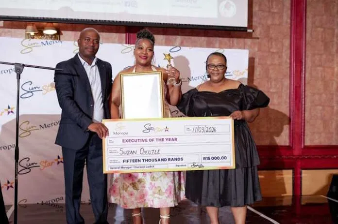 Adolf Makhubela, Cashiering Manager (left), and Charlene Ludick, General Manager (right), present Suzan Dikutle, Assistant Gaming Manager, with the coveted Executive of the Year award.