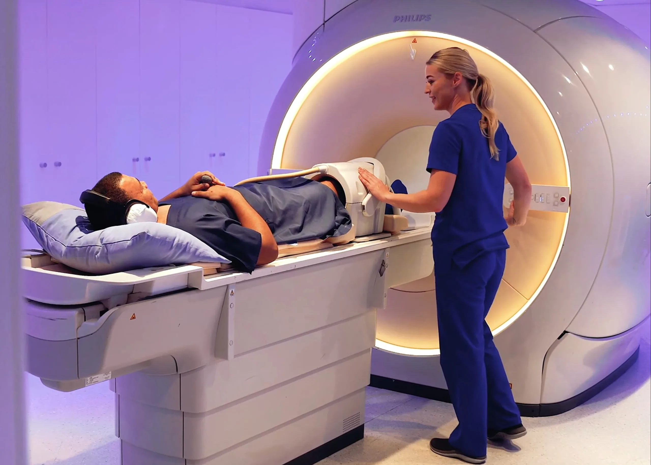 A patient with a knee replacement undergoing an MRI where modern technology reduces the distortions in the images