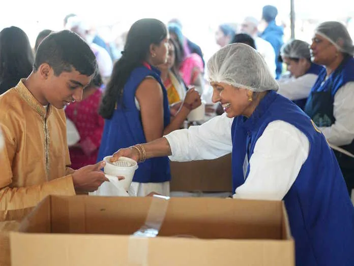 Over 15,000 packed lunch meals, fruits, bottled water, and rhot prasad were given to all attendees
